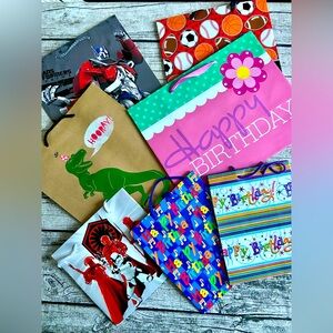 NEW. Bundle of 7 kids birthday gift bags. Assorted designs and sizes.